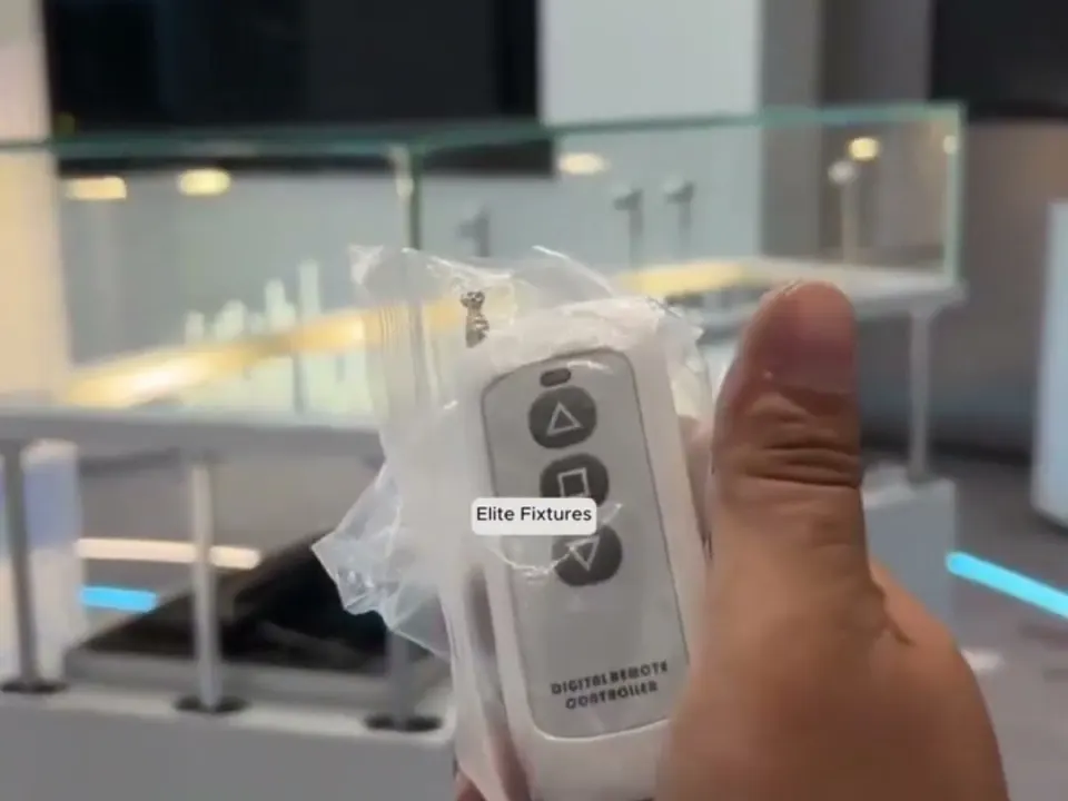 Remote control for a motorized jewelry display case, with lift-up glass showcases behind