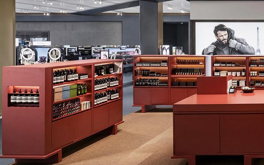 Retail casework run with wall shelving and service counters